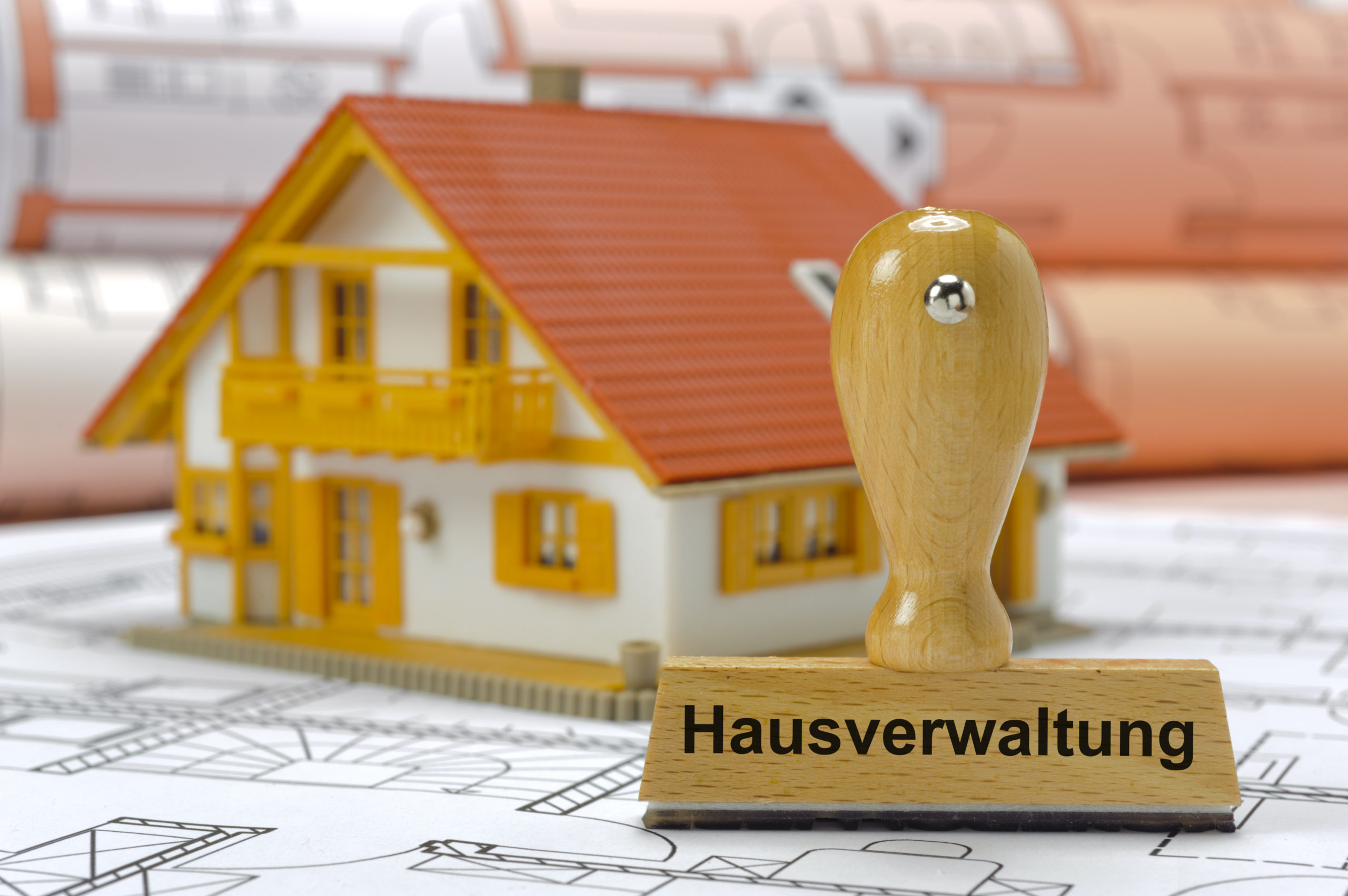 property management printed on rubber stamp standing on plan – in German language: Hausverwaltung